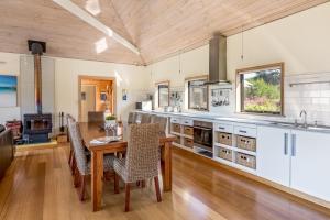 a kitchen with a wooden floor and a table and chairs at Main Break in Dunsborough
