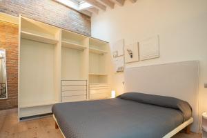 a bedroom with a bed and a brick wall at Casa del Sarto in Mantova
