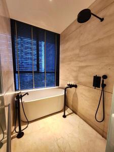 a bathroom with a bath tub and a window at 1 Bedroom near KLCC, Jalan Kia Peng in Kuala Lumpur