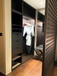 a walk in closet with a dresser and a mirror at 1 Bedroom near KLCC, Jalan Kia Peng in Kuala Lumpur