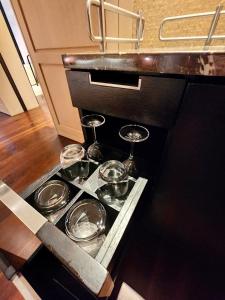 a tray with three wine glasses on a kitchen counter at 1 Bedroom near KLCC, Jalan Kia Peng in Kuala Lumpur