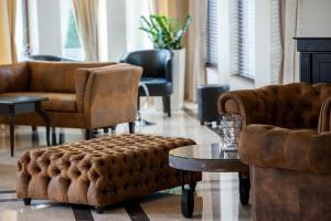 a living room with couches and chairs and a table at Mantar Spa Hotel in Marikostinovo