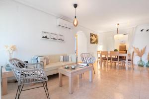 a living room with a couch and a table at Es Mirador - Cales de Mallorca in Calas de Mallorca