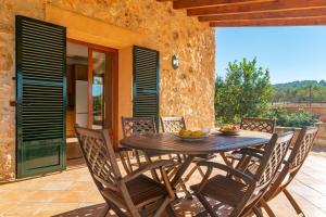 a wooden table and chairs on a patio at Cas General -Santa Eugenia- in Santa Eugenia