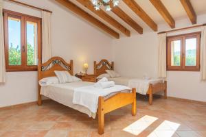 a bedroom with two beds and two windows at Cas General -Santa Eugenia- in Santa Eugenia +30 photos