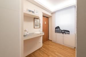 a room with a hallway with a desk and a door at Top Floor Colosseo Guesthouse in Rome