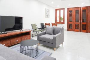 uma sala de estar com um sofá e uma televisão em Splendor Trendy Aparment em Hanói