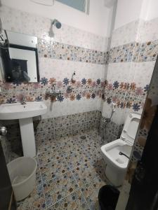 a bathroom with a sink and a toilet at HOTEL AMIGOS in Hyderabad