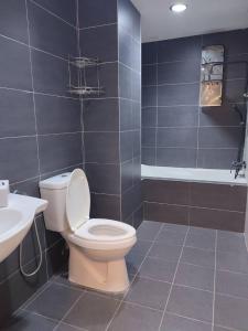 a bathroom with a toilet and a sink at Daxxlence Swimming Pool Homestay Kinta RiverFront in Ipoh