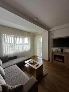 a living room with a couch and a fireplace at Gondola Mako Exclusive in Zlatibor