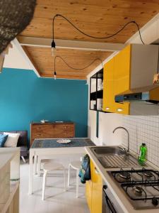 a small kitchen with a sink and a table at SeaHarbour Pesaro in Pesaro