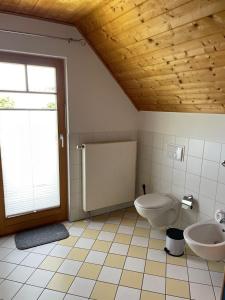 a bathroom with a toilet and a sink at Das gelbe Landhaus in Tellig