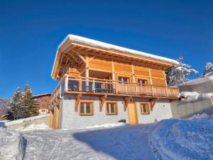 a log house with a balcony in the snow at Chalet Notre-Dame-de-Bellecombe, 6 pièces, 12 personnes - FR-1-505-99 in Notre-Dame-de-Bellecombe