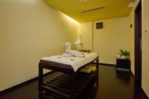 a room with a hospital bed in a room at Flora Airport Hotel and Convention Centre Kochi in Nedumbassery