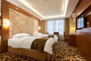 Ένα ή περισσότερα κρεβάτια σε δωμάτιο στο Howard Johnson Paragon Hotel Beijing Centra Provide tourism and ticketing service
