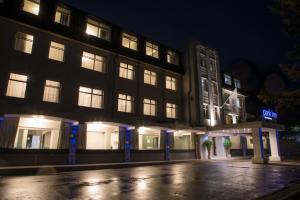 a building with lit up windows at night at Park Inn by Radisson Bournemouth in Bournemouth