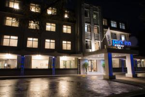 a building with a sign that reads penalty inn at night at Park Inn by Radisson Bournemouth in Bournemouth