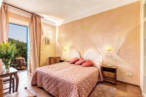 a bedroom with a bed and a large window at Villa Romita in SantʼAgata sui Due Golfi