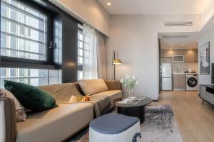 a living room with a couch and a table at BORUISI Executive Apartment in Shenzhen