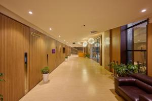an office hallway with a long corridor with plants at Flora Airport Hotel and Convention Centre Kochi in Nedumbassery