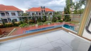 a balcony with a view of a swimming pool at REAL HOME 3 in Jinja
