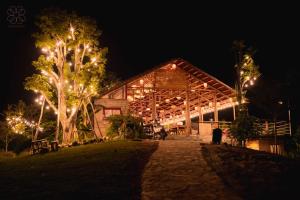 a barn lit up at night with lights at Đồi Gió Retreat in Hanoi