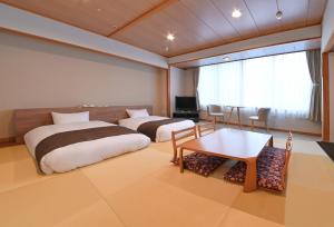 Postel nebo postele na pokoji v ubytování 朝里川温泉ホテル