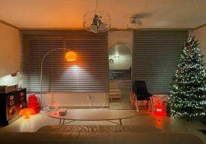 a living room with a christmas tree and a table at Aufn Orange Bulb in Seoul