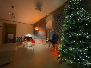 a living room with a christmas tree in a living room at Aufn Orange Bulb in Seoul