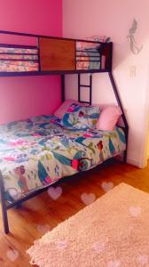 a bedroom with a bunk bed in a pink wall at City Center Home ONeal lane in Baton Rouge