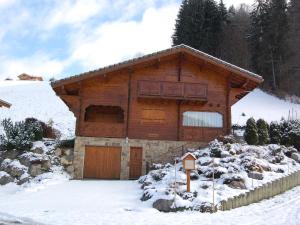 a large wooden house with snow on the ground at Chalet Les Gets, 5 pièces, 9 personnes - FR-1-623-51 in Les Gets