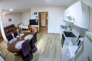 a kitchen and dining room with a table and chairs at Zimzeleni Apartments in Zreče