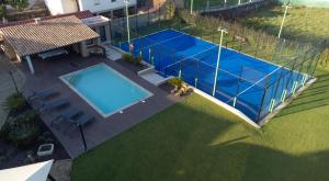 an overhead view of a swimming pool with a tennis court at Casa Grande Gondomil com Campo de Padel, Piscina in Valença