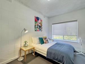 a bedroom with a bed and a window at The Cosy Corner - Your Chic Adelaide Base in Wayville