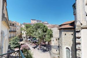 a view of a city street with trees and buildings at Mas Saint Côme - Superbe appartement 4 chambres Centre Historique in Montpellier