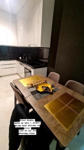 a kitchen with a wooden table with bananas on it at Apartment 06 in Gjilan