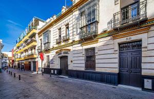 a building on the side of a street at Carmen de Triana in Seville