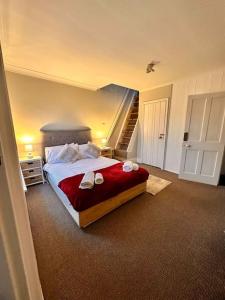 a bedroom with a bed and a staircase in it at Charming 2 Bedroom Cottage in Staines Upon Thames in Staines upon Thames