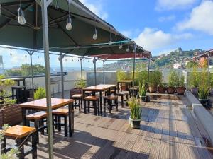 a patio with tables and chairs on a roof at Misty Hills in Baguio