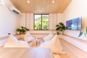 a living room with white pillows and a table at HAKO REIRO 箱・玲瓏 in Hakone