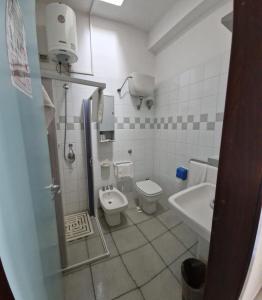 a bathroom with a toilet and a sink at Hotel Solara in Conca Specchiulla