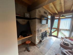 ein Wohnzimmer mit einem Steinkamin in einem Haus in der Unterkunft Katarino Spa Chalet in Raslog