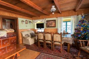 a living room with a christmas tree and a table at Pri Macku in Tolmin