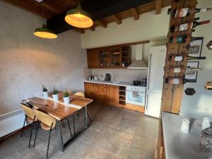 a kitchen with a wooden table and a refrigerator at Katarino Spa Chalet in Razlog