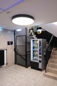 a vending machine in a building with a staircase at City Stay Vienna – Lugeck in Vienna