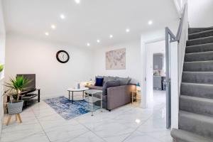 a living room with a couch and a table at 3 Bedroom House with Parking in Windsor - Family and Contractor friendly in Windsor