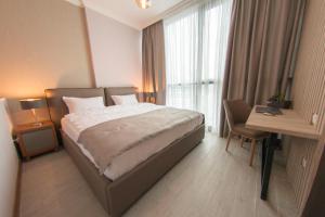 מיטה או מיטות בחדר ב-Season Suite Apart-Hotel