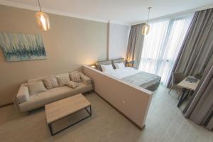 מיטה או מיטות בחדר ב-Season Suite Apart-Hotel