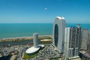 a view of a city with tall buildings and the ocean at Season Suite Apart-Hotel in Batumi