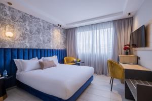 a hotel room with a bed and a desk at Kenzi Solazur in Tangier